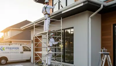 Professional trim and fascia painting on a Newton MA home exterior by expert house painters